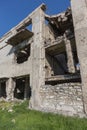 Abandoned destroyed by the explosion, bombing and shelling the destroyed building. Holes from shells, traces of bullets and splint Royalty Free Stock Photo