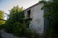 Abandoned dilapidated old brick building, broken glass from wooden frames, with ground overgrown with grass Royalty Free Stock Photo