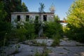 Abandoned dilapidated old brick building, broken glass from wooden frames, with ground overgrown with grass Royalty Free Stock Photo