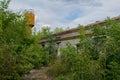 Abandoned dilapidated old brick building, broken glass from wooden frames, with ground overgrown with grass Royalty Free Stock Photo