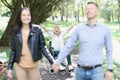 Abandoned disabled woman sits in wheelchair in park stretches arms forward and shouts no Royalty Free Stock Photo