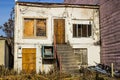 Abandoned Distressed Two Story Building With Boarded Up Windows & Doors Royalty Free Stock Photo