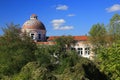 Abandoned dome building with overgrown vegetation and blue sky in background Royalty Free Stock Photo