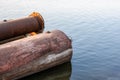 Abandoned dredging pipes on the river close up shot with copy space Royalty Free Stock Photo