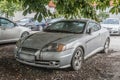 Abandoned wreck of scrap dusty and dirty Hyundai sport car parked Royalty Free Stock Photo