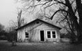 Abandoned empty old house with dead trees Royalty Free Stock Photo