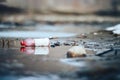 Abandoned empty pink plastic bottle garbage at the river bank conservancy pollution