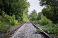 Abandoned empty unused railway track in the forest