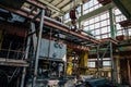 Abandoned factory inside interior with equipment, iron rigs, pipes