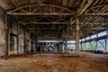 Abandoned factory. Large empty industrial hall waiting for demolition Royalty Free Stock Photo