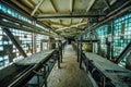 Abandoned factory. Old dusty conveyor belt in old corridor of glass brick Royalty Free Stock Photo