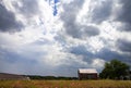 Abandoned farm with storm clouds