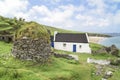 Abandoned farmhouse Great Blasket Island, Ireland. Farmhouse and round building from natural stone slabs with grass on roof. Royalty Free Stock Photo