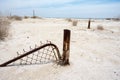 Abandoned fence gate sits buried in the sand in Bombay Beach California, an abandoned town at the Salton Sea Royalty Free Stock Photo