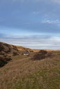 An abandoned Fishermen\'s Cottage and Ice house set back from the beach at St Cyrus, Royalty Free Stock Photo