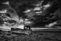 Abandoned fishing boat on beach landscape at sunset black and white