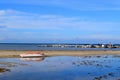 Abandoned fishing boat at ebb tide. Blue sea, Thessaloniki, Greece wide angle Royalty Free Stock Photo