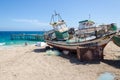 Abandoned fishing boats fading away on deserted beach in Angola