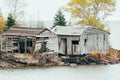 Abandoned fishing shacks or cabins, on Two Fishhouse Beach along Lake Superior shoreline in Minnesota, during fall