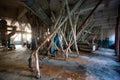 Abandoned flour milling factory. Old rusty roller mill equipment with pipeline