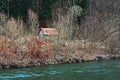 Abandoned forest hut by the river