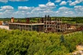 Abandoned forgotten ruined chemical plant overgrown by plants and trees, aerial view