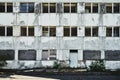 Abandoned former administration building, slowly decaying, without windows and panes, ugly, weathered