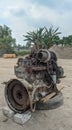 An abandoned four-cylinder diesel engine in the open