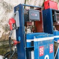 Abandoned fuel pump with red fuel nozzle