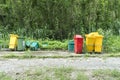 Abandoned garbage bin beside street background. Deserted trash can in the forest park Royalty Free Stock Photo