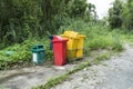 Abandoned garbage bin beside street background. Deserted trash can in the forest park Royalty Free Stock Photo