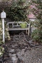 Abandoned garden, bench with a watering can, retro garden decorations. Vintage background Royalty Free Stock Photo