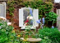 abandoned garden with flowers and a window