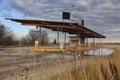 Abandoned gas station against dramatic sky