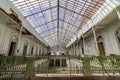 Abandoned girls high school, lycee V in Belgium. Large glass roof with broken windows.