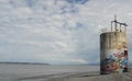 Abandoned graffiti covered tower on Arnchorage Alaska lake beach