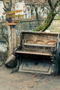 Abandoned gran piano, rundown piano by a river bank Vilnia river in Uzupis artists quarter in Vilnius