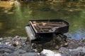 Abandoned gran piano, rundown piano by a river bank Vilnia river in Uzupis artists quarter in Vilnius, Lithuania, bohemian Royalty Free Stock Photo