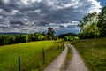 Gravel Road With Wooden Fence In Rural Landscape At Rainy Weather In Austria Royalty Free Stock Photo