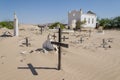 Abandoned graveyard with crumbling stones and crosses in Namib Desert of Angola
