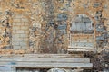 Abandoned grunge building with boarded up windows.