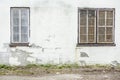 Abandoned grunge cracked brick stucco wall with a window grilles Royalty Free Stock Photo