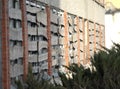 Abandoned grunge cracked brick wall with boarded up windows