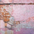 Abandoned grunge cracked red brick stucco wall.