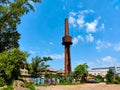 Abandoned historical tall industrial smokestack in the renovated business zone Pragovka during beautiful weather