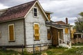 Abandoned Home In Disrepair With Boarded Up Windows