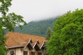 An abandoned hotel against the backdrop of mountains covered with fog. Royalty Free Stock Photo