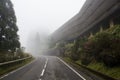 Abandoned hotel on mysterious road with fog