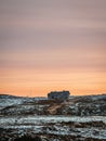 Abandoned house against the evening Arctic sky. Old authentic village of Teriberka