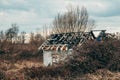 Abandoned house after arson in countryside landscape on cold autumn day